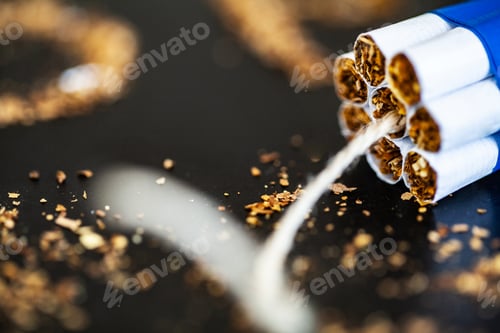 Preview: Stop smoking concept on background with broken cigarettes. Heap of cigarettes. No smoking