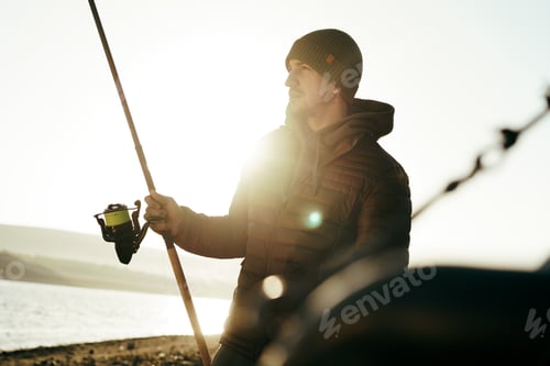 Preview: Male fisherman fishing at the lake at sunrise