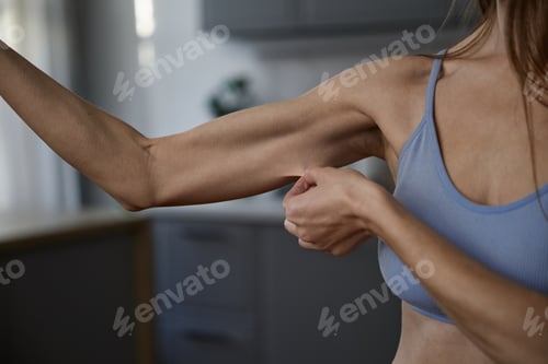 Preview: Midsection shot of anorexic woman touching skin on emaciated arms