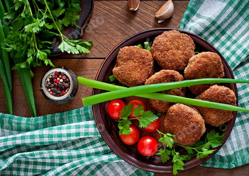 Preview: Juicy delicious meat cutlets on a wooden table in a rustic style.