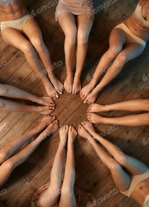 Preview: feet of dancers seated circle on floor