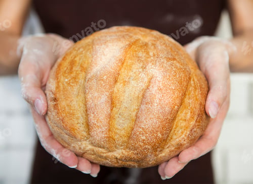 Preview: Fresh bread in female hands