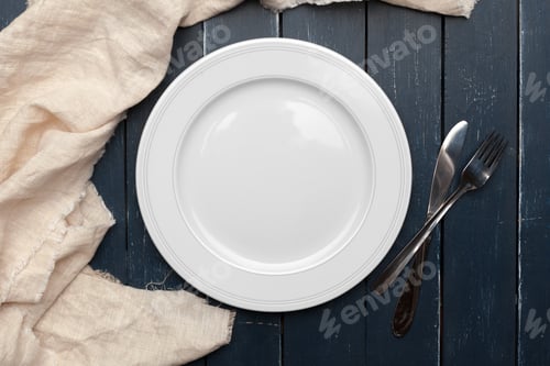 Preview: Empty plate and towel over wooden table background