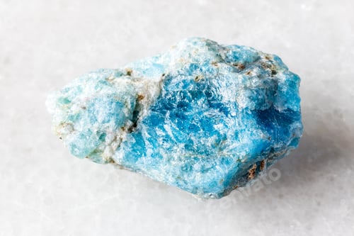 Preview: sample of unworked apatite mineral on white