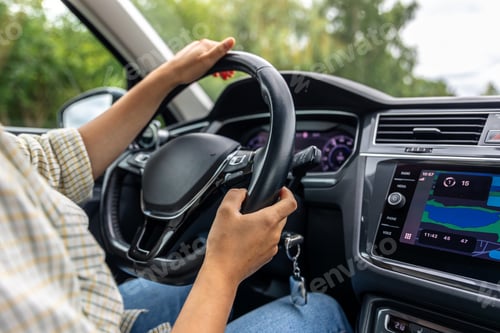 Preview: Female driver at car wheel. Navigation display. Modern vehicle interior