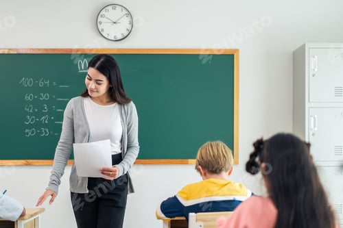 Preview: Group of student learn with teacher in classroom at elementary school.