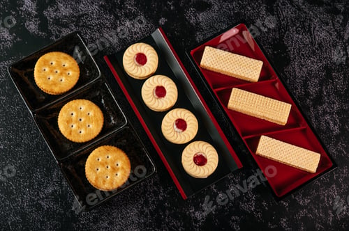 Preview: Many cookies are beautifully arranged in a plate and then placed on a wooden table.