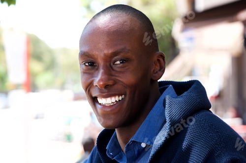 Preview: Close up smiling handsome black man outside