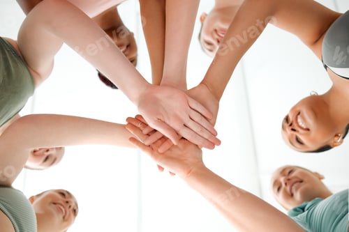Preview: They want it as much as you do. Shot of a group of fit young women joining their hands in a huddle.