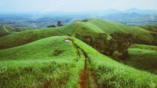 Preview: Campers on Green Hillside Hiking During the Daytime