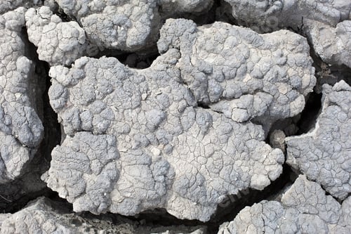 Preview: The texture of gray cracked earth, dried volcanic clay with cracks