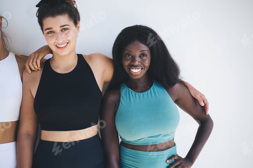 Preview: Caucasian and african American Models in tracksuit posing On white background in gym studio