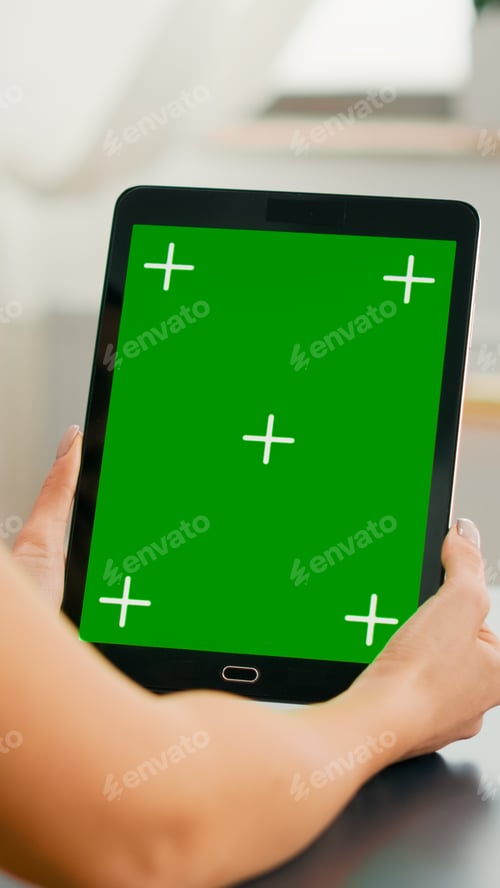 Preview: Freelancer woman holding tablet computer with mock up green screen