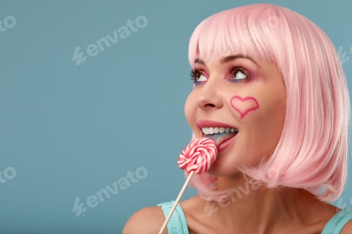 Preview: Candy Lolli pop Party Girl posing in blue studio. Role-playing games, halloween concept, sweet lover