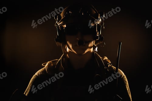 Preview: Portrait of special forces soldier in helmet and glasses in the dark