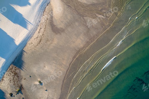 Preview: zenithal aerial drone view of a beach shore at sunrise