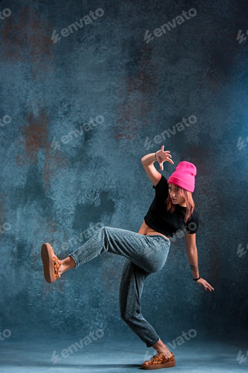 Preview: Young girl break dancing on wall background.