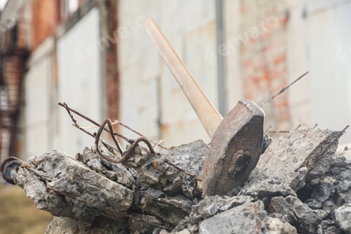 Preview: Sledgehammer on pile of broken stones outdoors, closeup