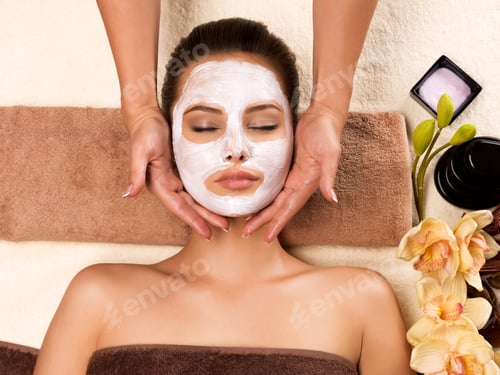 Preview: Woman with mask on her face having head massage.
