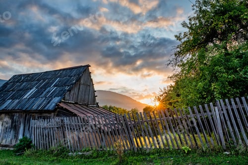 Preview: Sunset over the house and green trees in the countryside