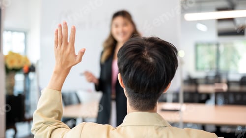 Preview: Close up man raising hand asking question to woman speaker after explaining plan on board in office.