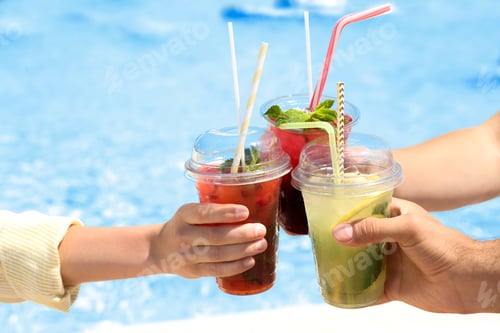 Preview: People with refreshing drinks in water park, closeup