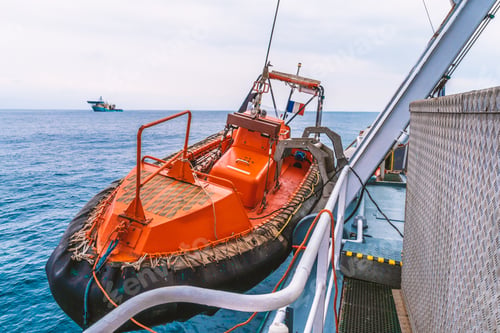 Preview: Lifeboat or FRC rescue boat in the vessel at sea. dsv ship is on background