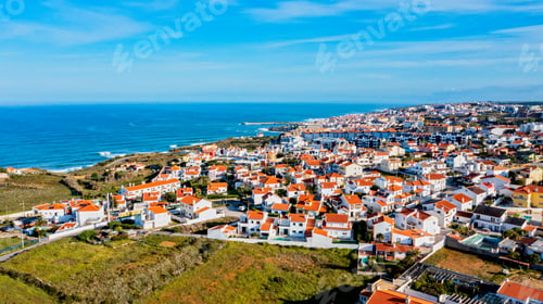 Preview: Aerial view of a small European town against blue sky and Atlantic Ocean. Drone view of Portugal.