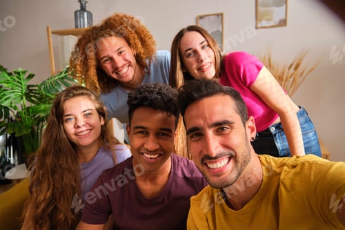 Preview: Group of cheerful young friends taking selfie, looking at the camera smiling.