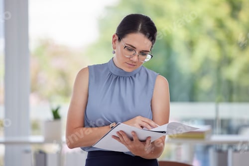Preview: Business woman, paperwork and reading at the office for financial report, analysis or information.