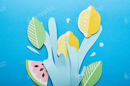 Preview: top view of paper cut water splash with lemons, leaves and watermelon on bright blue background