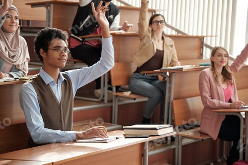 Preview: Students Raising Hands in College Classroom Setting