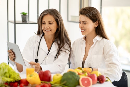 Preview: Happy mature caucasian doctor nutritionist in white coat consultation young woman