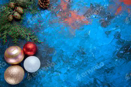 Preview: top view fir tree branches fir tree branches cones xmas tree toys on blue background free place