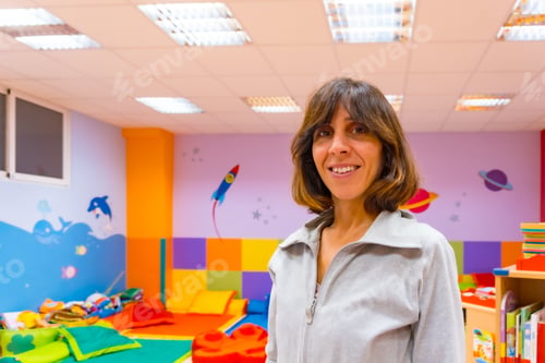 Preview: Portrait of a kindergarten or early childhood education teacher inside a kindergarten, with a child