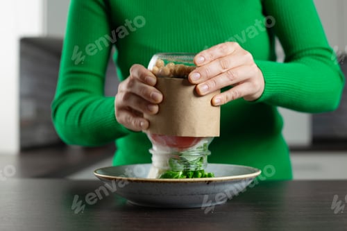 Preview: Woman eat vegan salad from jar with chickpea. Healthy homemade food concept.