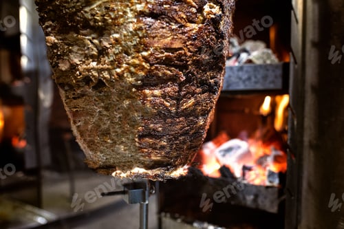 Preview: Close up shot of stacked meat roasting to be used in preparation of traditional Greek dish gyros or