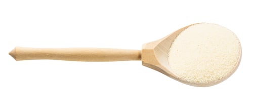 Preview: wood spoon with soft wheat manna groats isolated