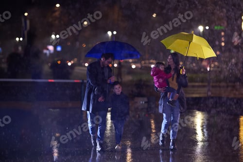 Preview: In the midst of a rainy urban night, a happy couple takes their children on a stroll through the