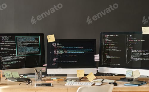 Preview: Row of three computer monitors with coded data on screens standing on table