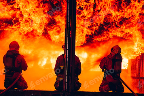 Preview: Fearless Firefighters Battling Blaze with Water and Extinguishers.