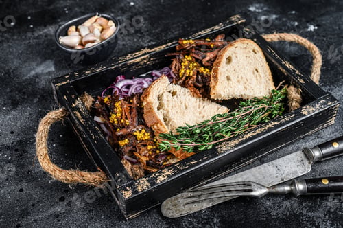 Preview: Brisket Sandwich with smoked beef meat in a wooden tray. Black background. Top view