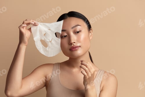 Preview: Beauty Woman Face Mask. Portrait Of Beautiful Girl Removing Sheet Mask