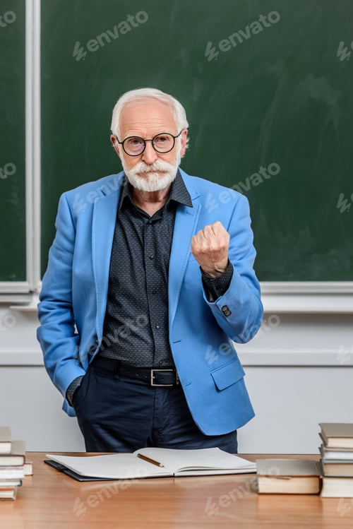 Preview: grey hair professor showing fist to students