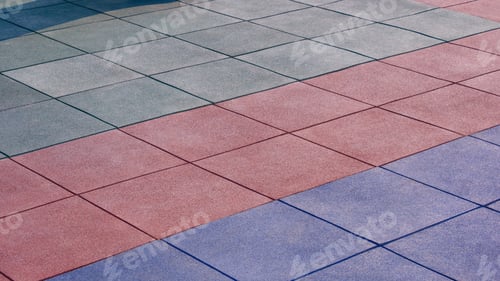 Preview: Multicolored EPDM rubber floor texture background of outdoors playground with sunlight on surface