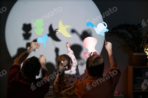 Preview: Caucasian Family Creating Shadow Puppets Together during Indoor Playtime
