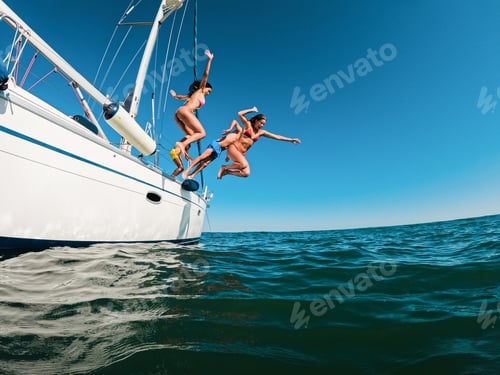 Preview: Happy friends diving from sailing boat into the sea