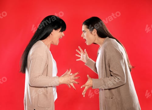 Preview: Young daughter and her mature mother arguing on color background