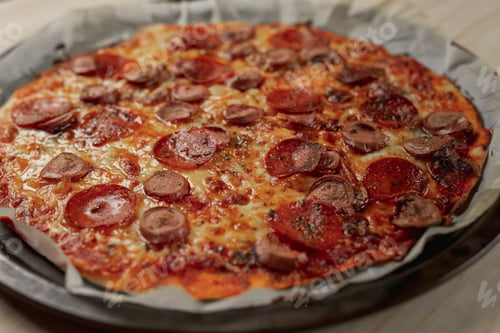 Preview: Overhead photography of a homemade pepperoni and sausage pizza