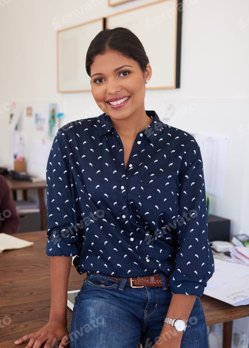 Preview: My career keeps me smiling. Portrait of a confident young businesswoman working in a modern office.